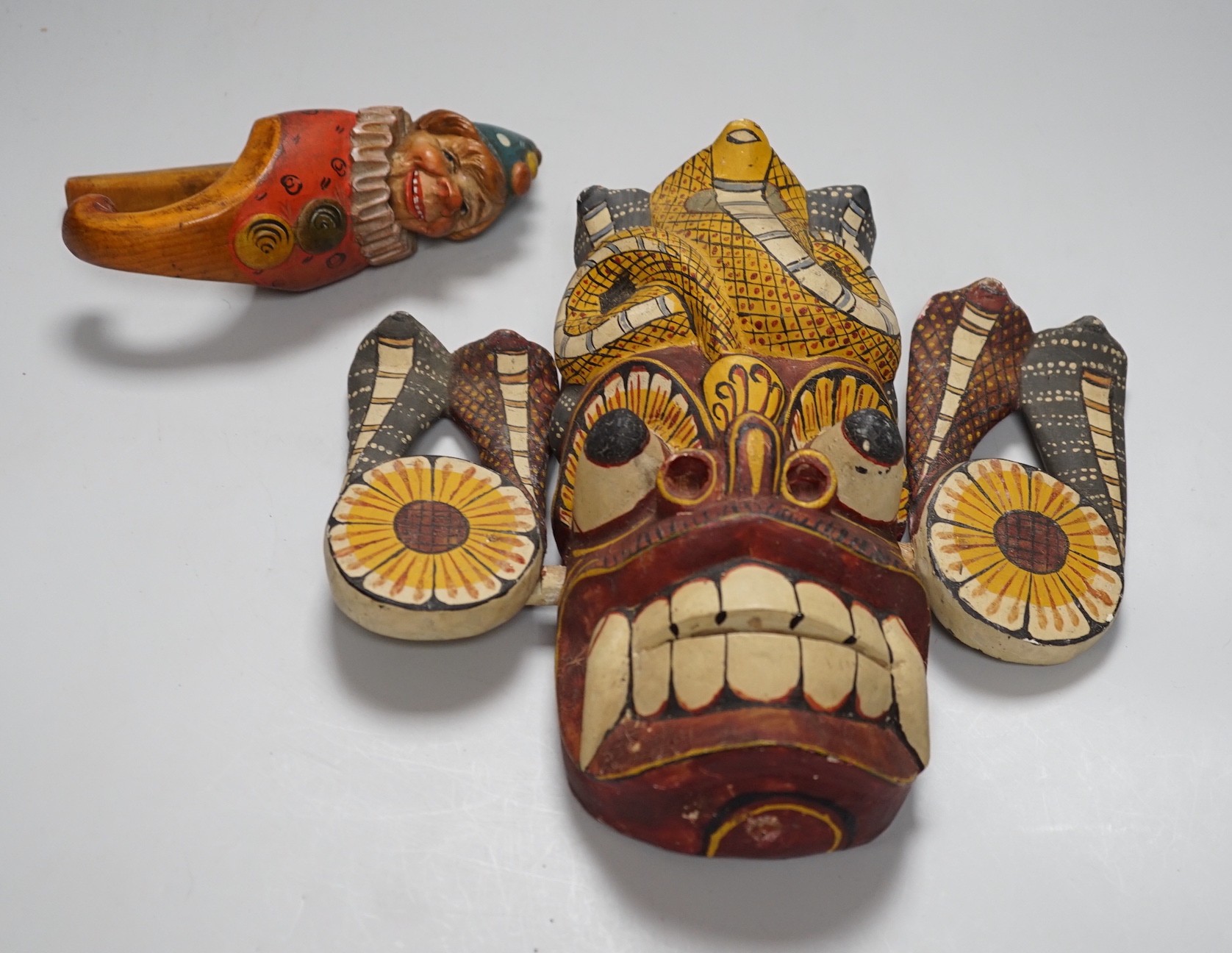 An African Tribal wood mask and a novelty figural carved wood nutcrackers, mask 27cms high